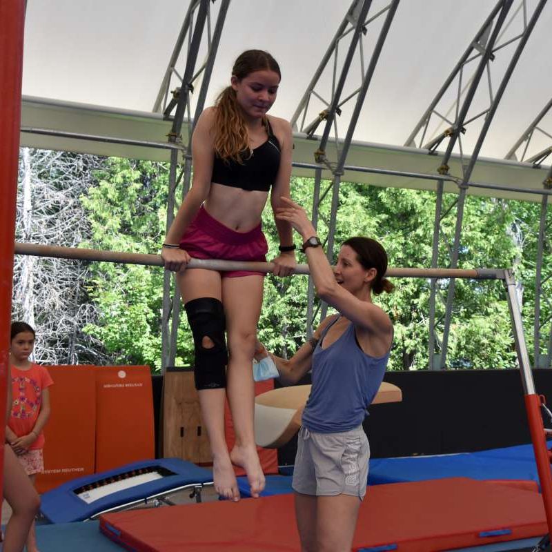 gymnastics coach training a camper at Canadian Adventure Camp