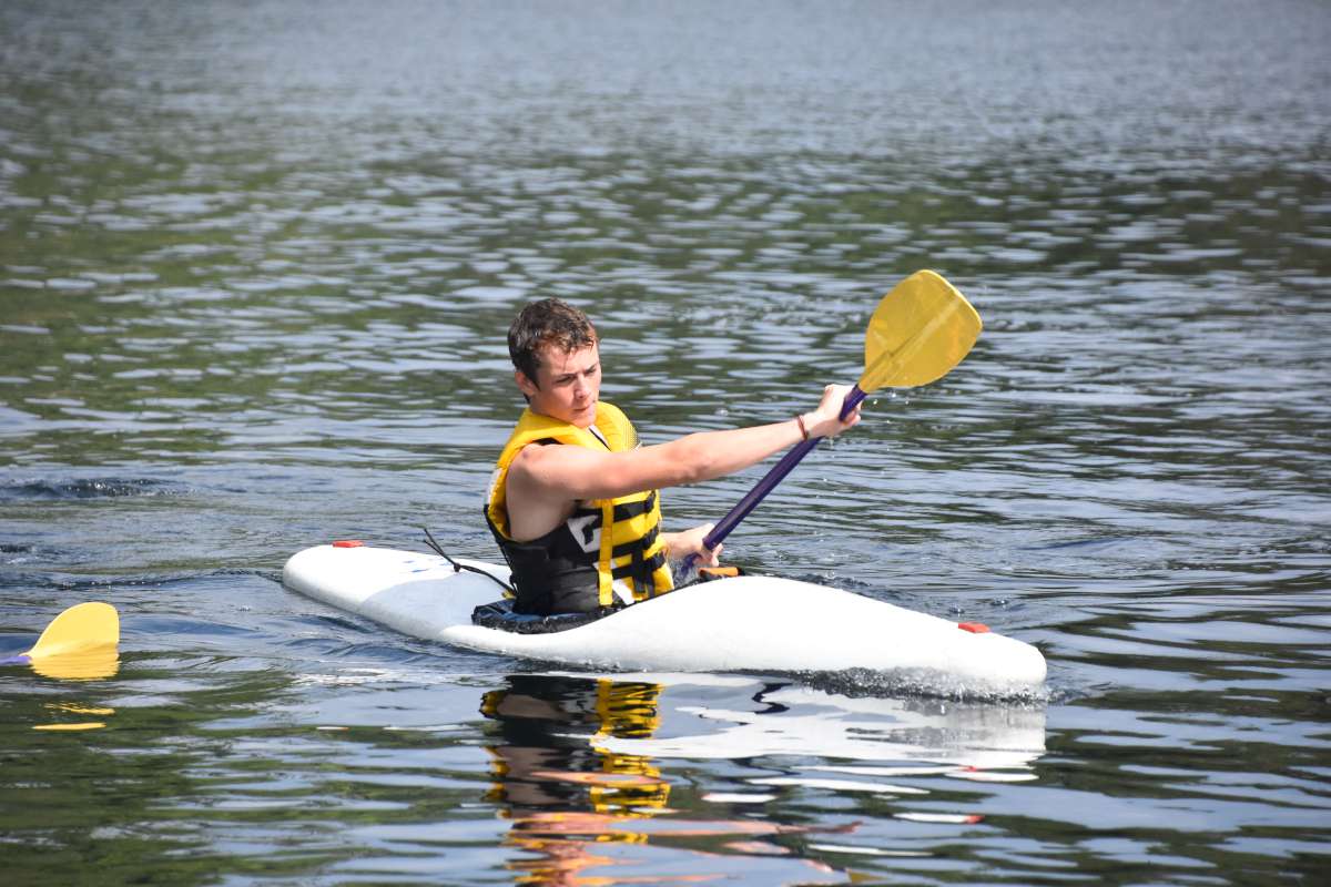 Senior boy camper kayaking on the lake at Canadian Adventure Camp