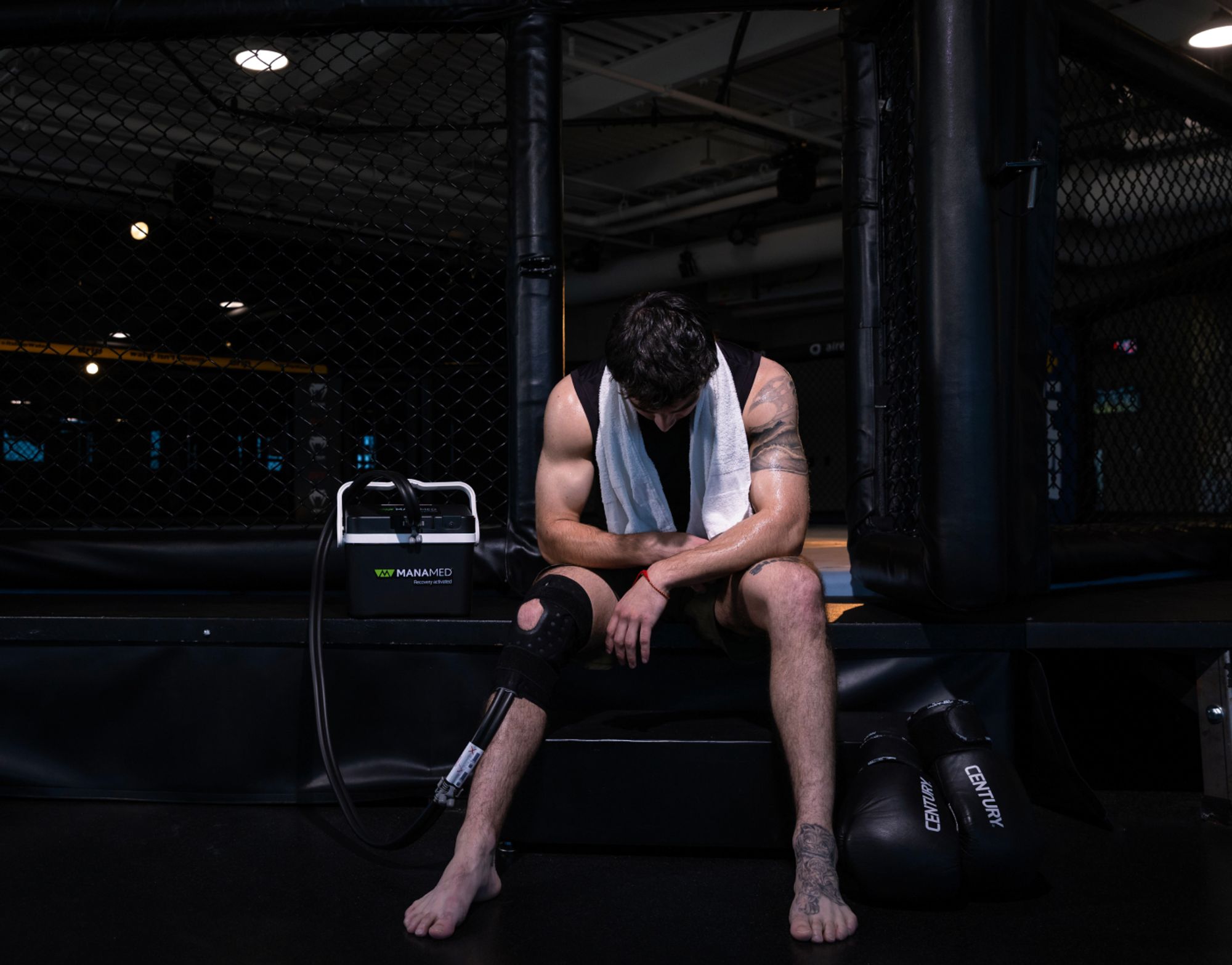 Athlete using ManaCold Therapy Unit ringside at a UFC match.