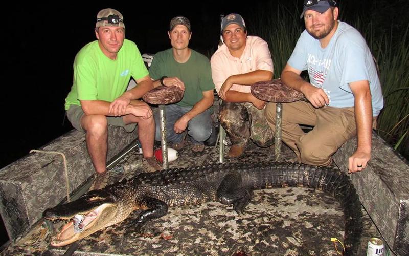Alabama alligator hunter posing with a harvested gator
