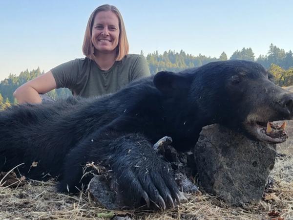 Hunter shown with black bear after a guided California black bear hunt.