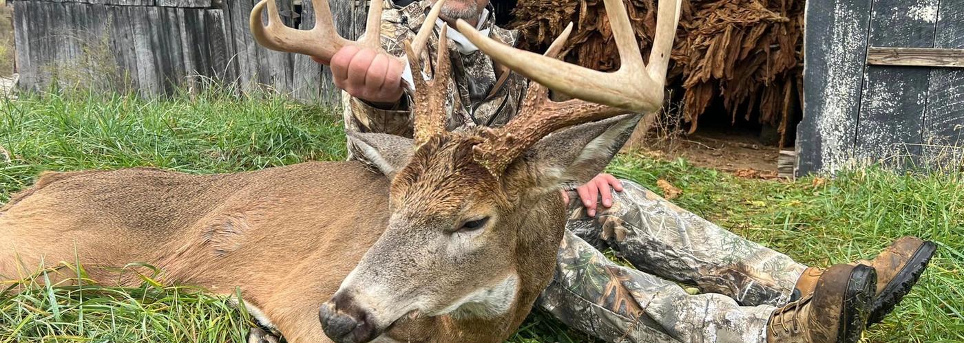 Hunter with mature whitetail buck during a guided deer hunt