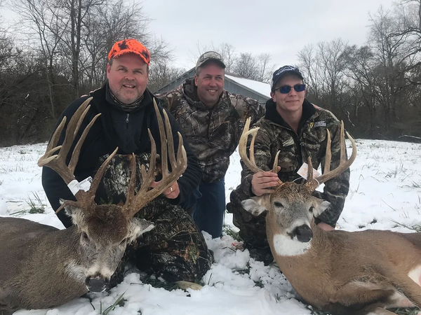 Mature whitetail buck standing in an Illinois agricultural field during a guided deer hunt.
