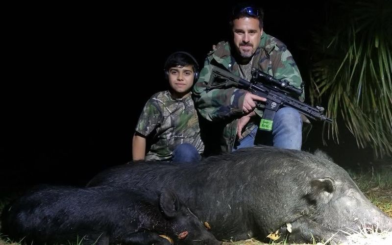 Young hunter with parent during a guided hog hunt