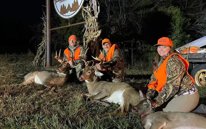 Young hunter and parent sitting together during a whitetail deer hunt