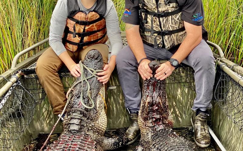 Texas alligator hunter with harvested gator near a private hunting property