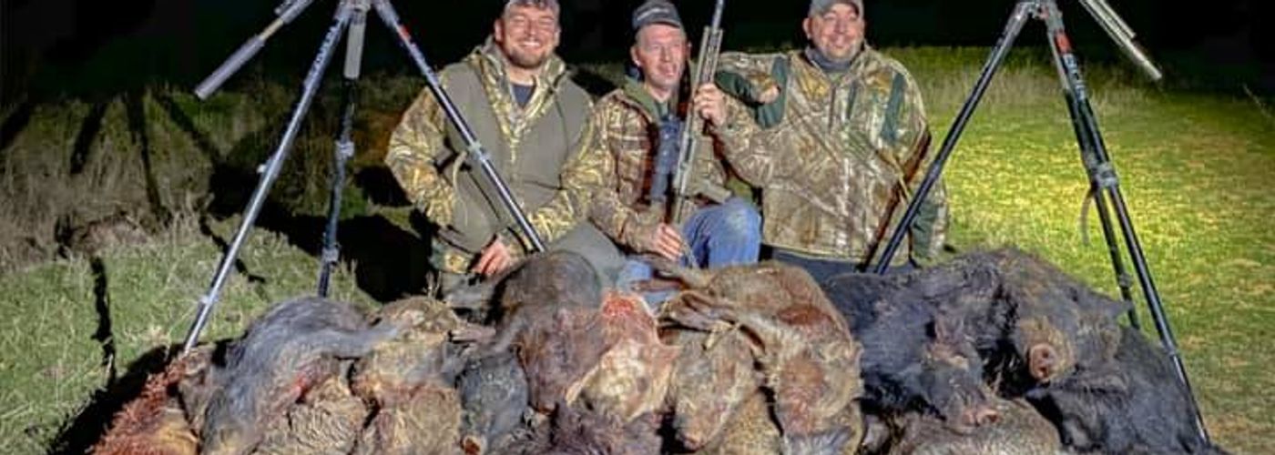 Group of hunters after night time hog hunt with thermals in Oklahoma.