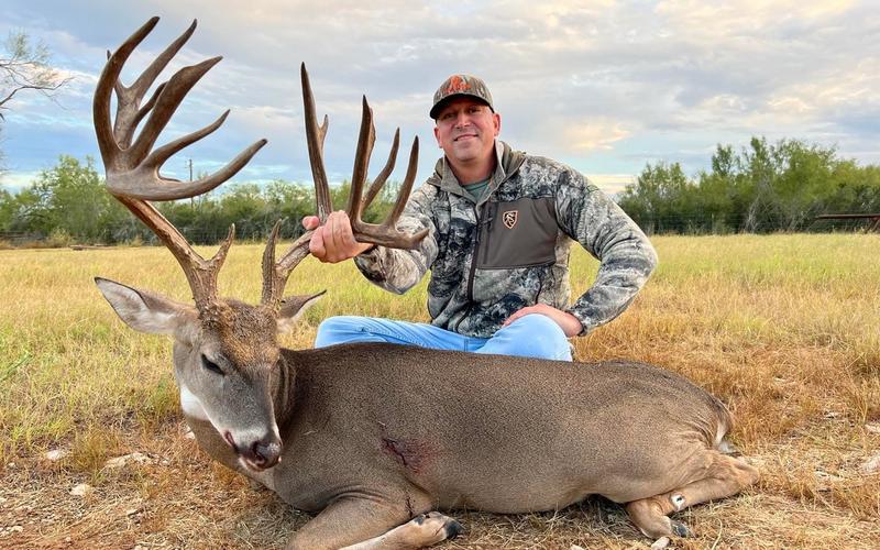 Hunter with a trophy Texas whitetail buck on a private ranch