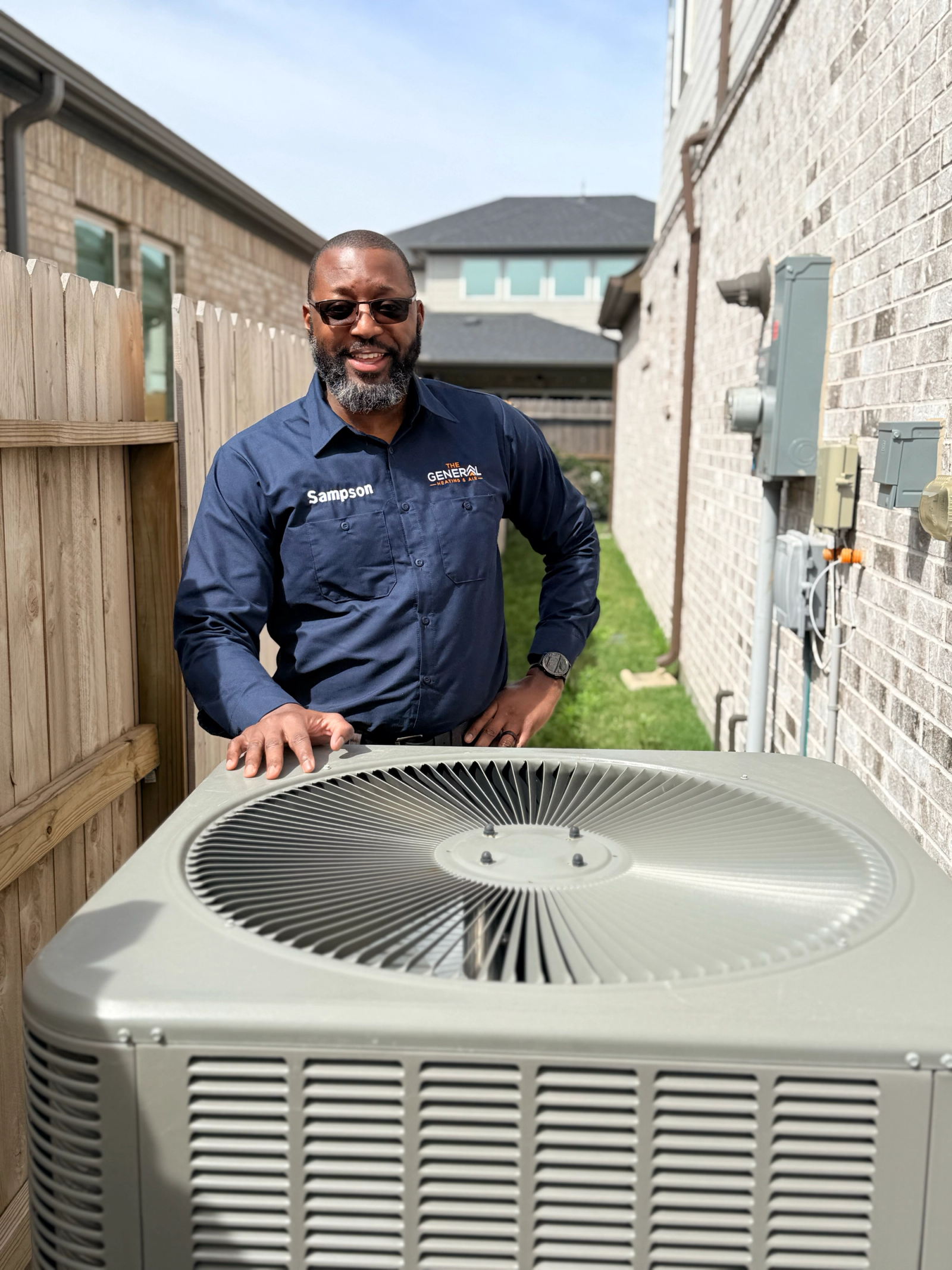 An outdoor AC condenser unit beside a home