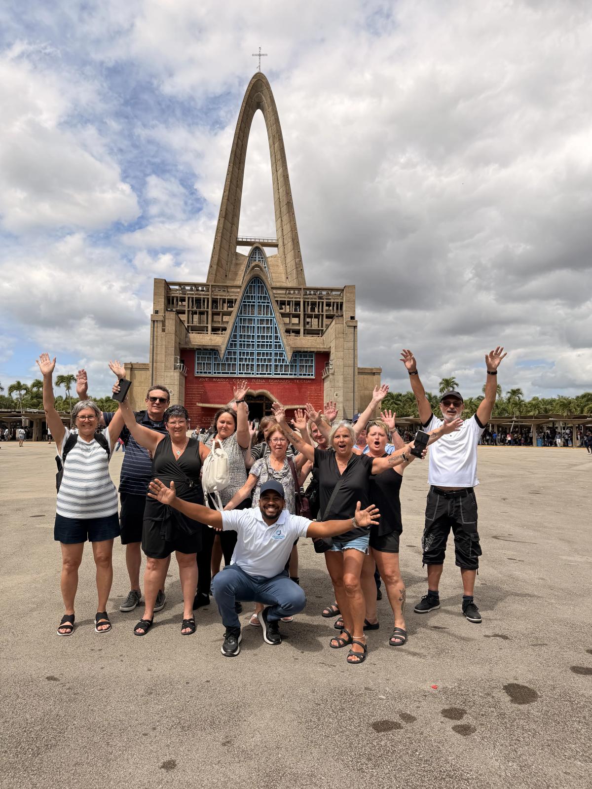 CJ Transfer driver welcoming a large family group at Punta Cana International Airport arrivals