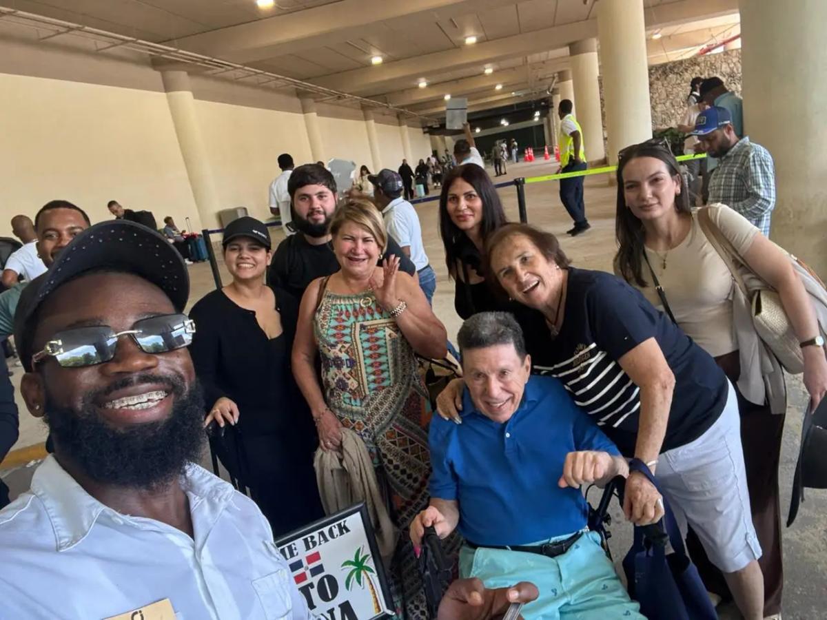 CJ Transfer driver welcoming a large family group at Punta Cana International Airport arrivals
