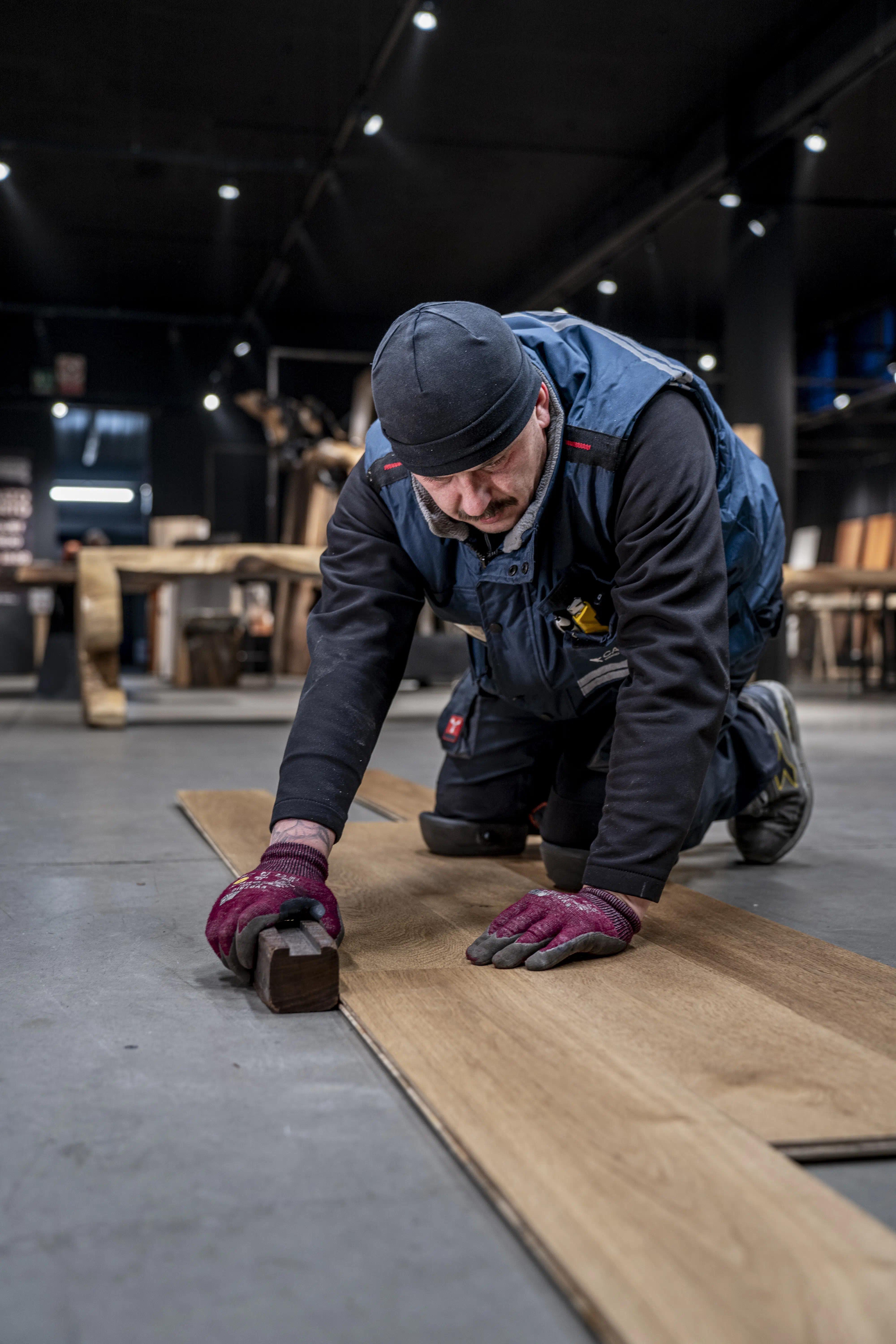 Artigiano di Cabbia che posa il parquet