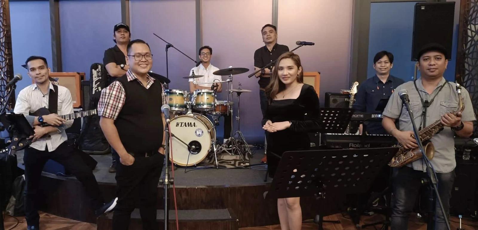 J-Project's musicians performing together with vocals, guitar, bass, keyboards, and drums