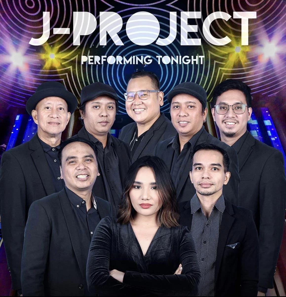 J-Project promotional group portrait with eight musicians in black formal attire