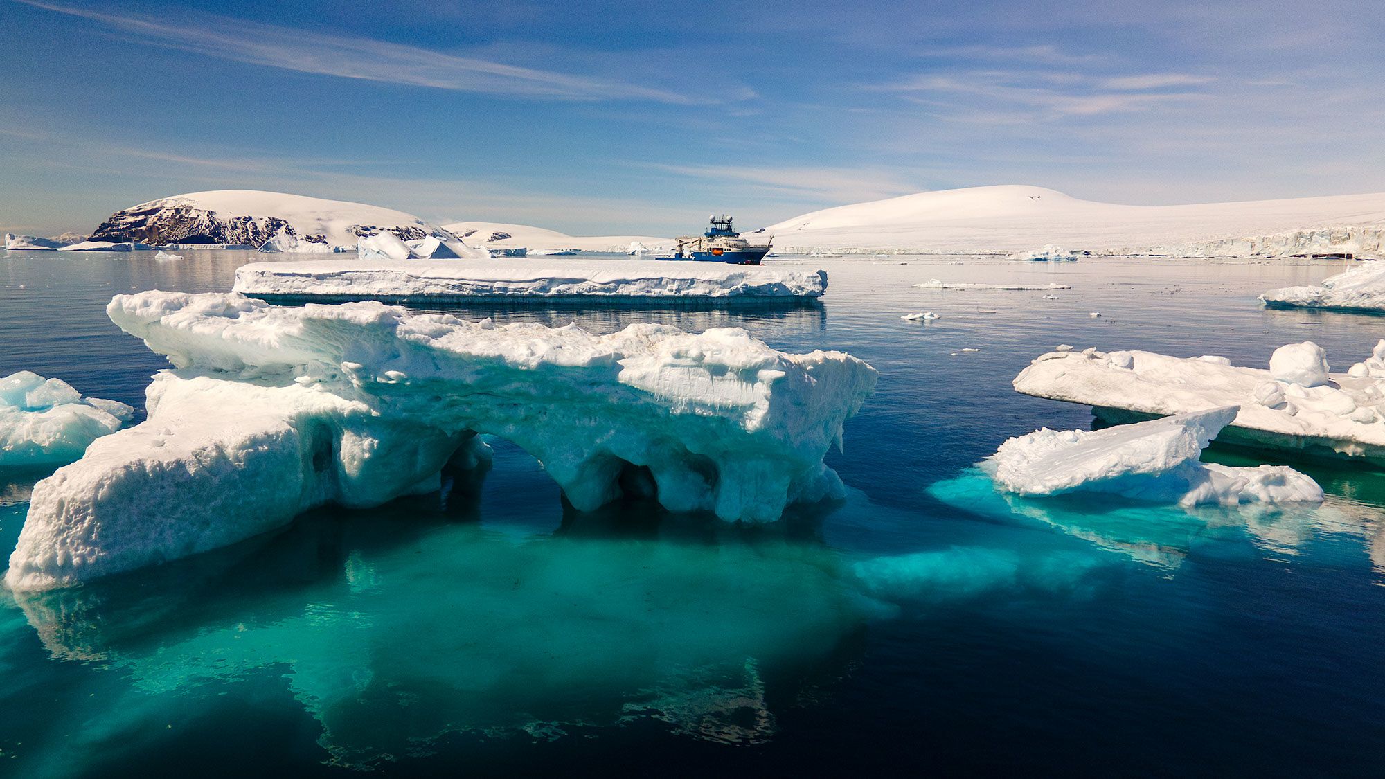 A research vessel surrounded by sea and icebergs