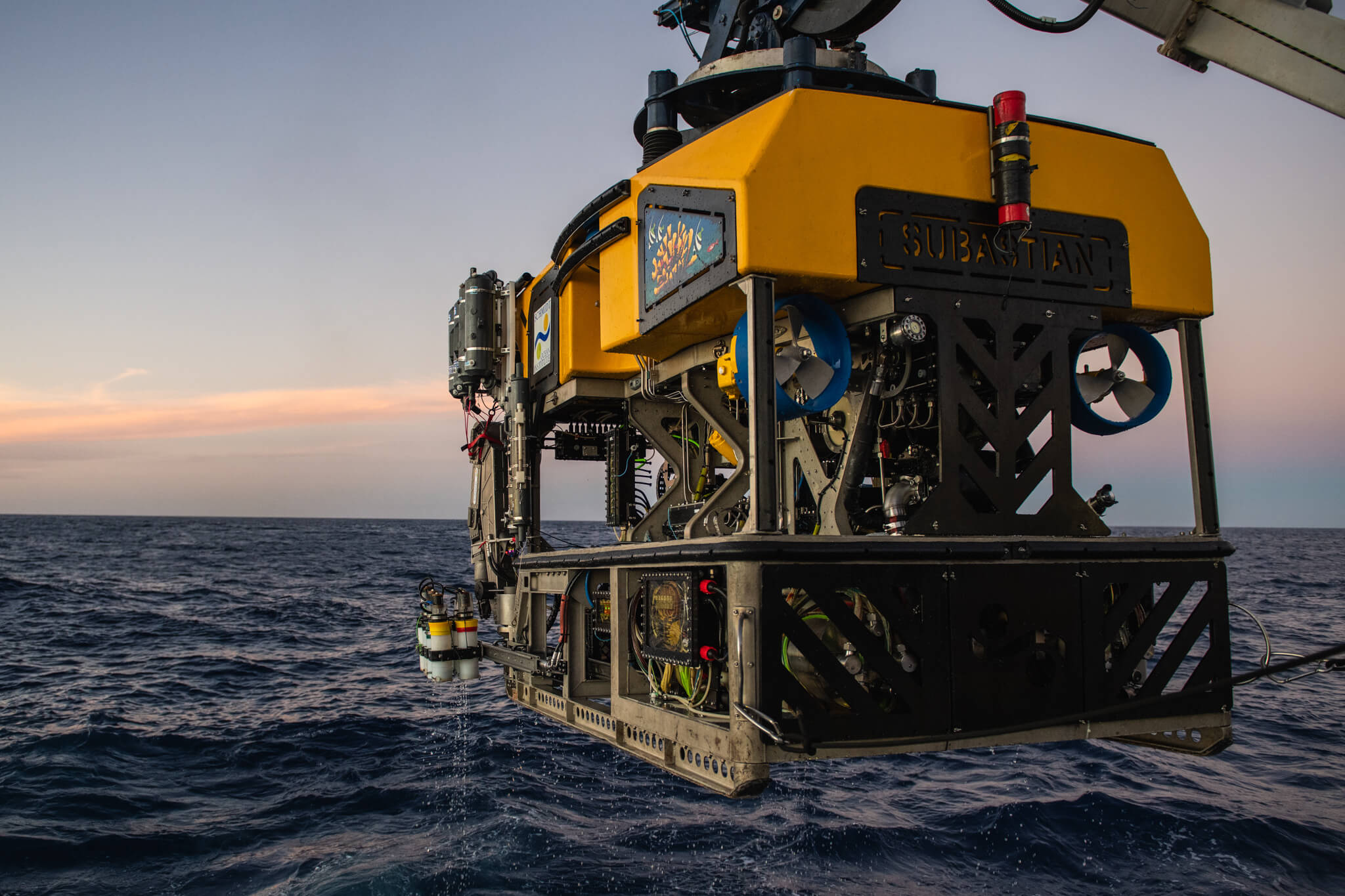 Underwater rover being lifted into the water by crane
