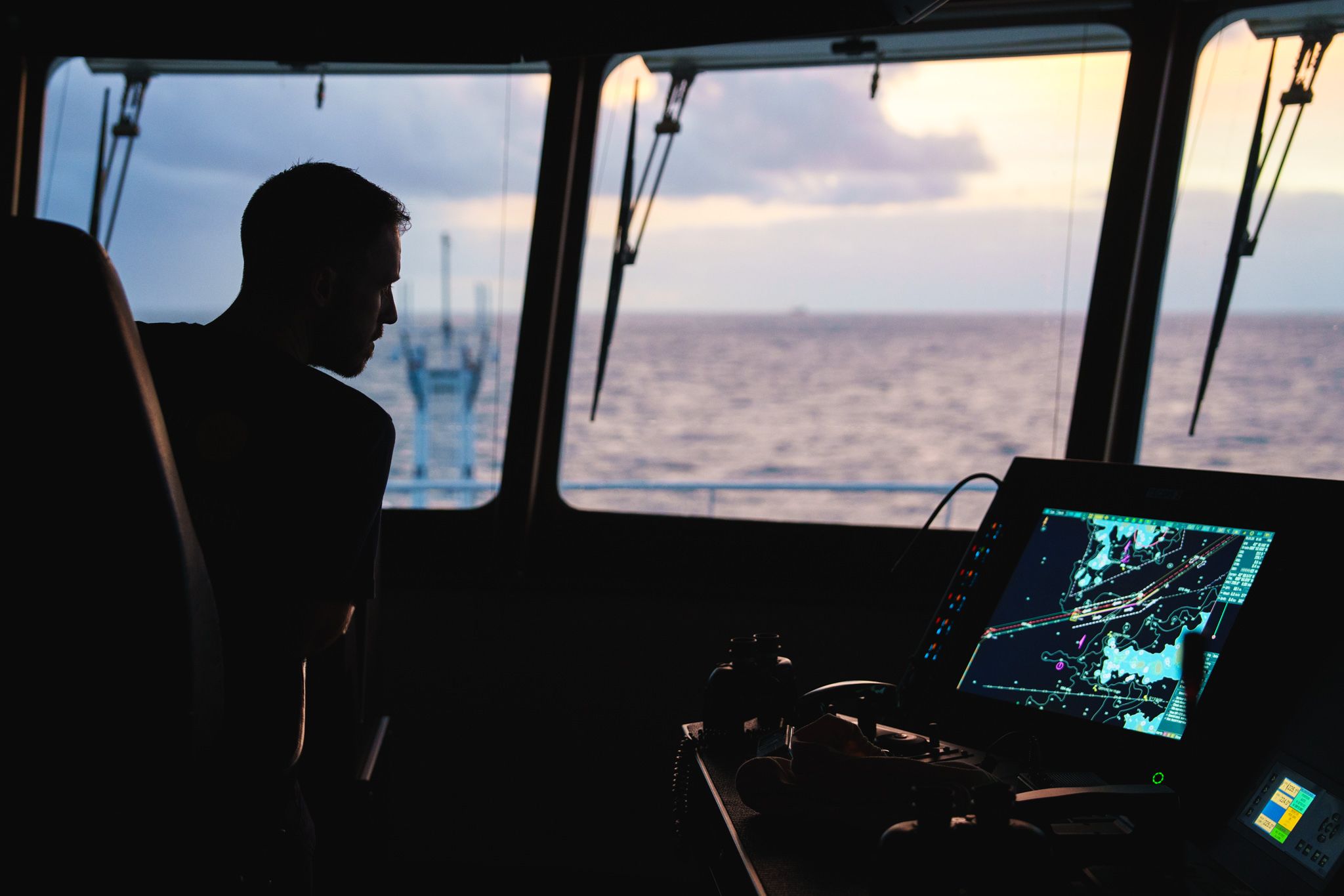Bridge officer reviews the ecdis chart while on the bridge.