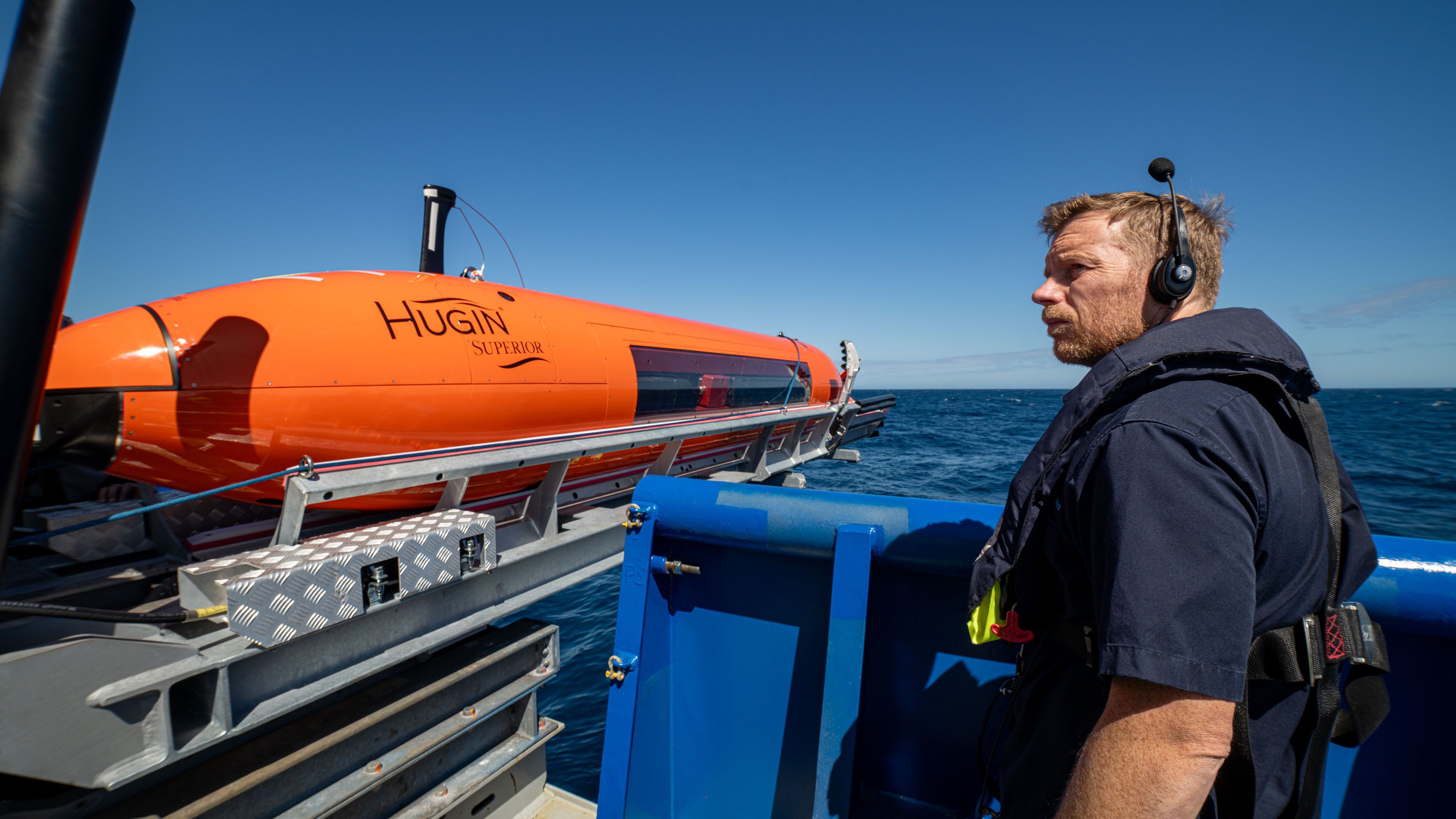 the AUV is being prepared to launch as the AUV supervisor looks on. 