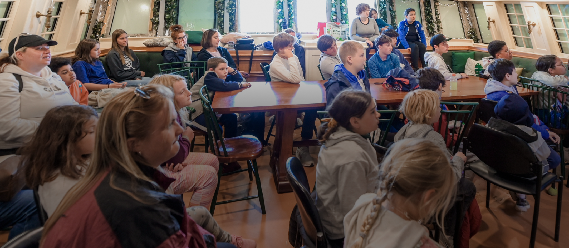 Young children sitting inside hull of ship