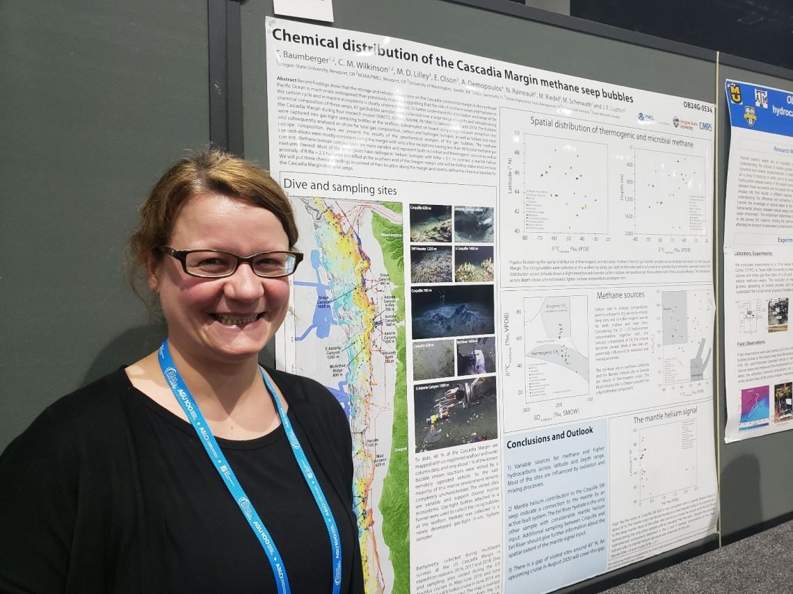 Woman standing next to science poster