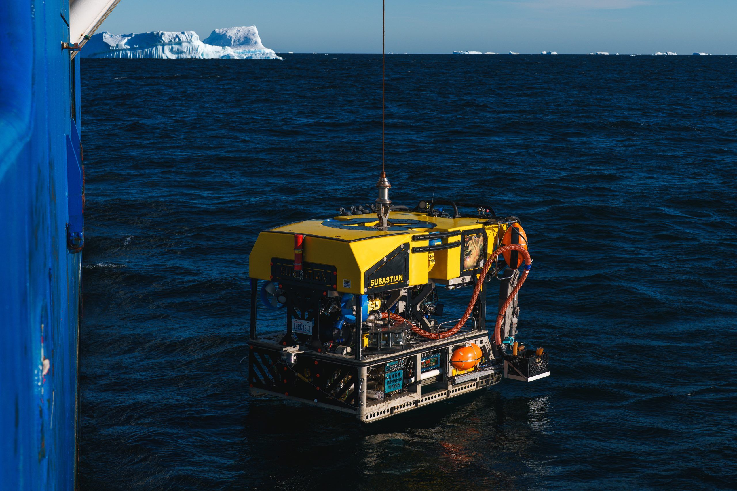 Remotely Operated Vehicle SuBastian is deployed off Antarctica. An Iceberg is in the background.
