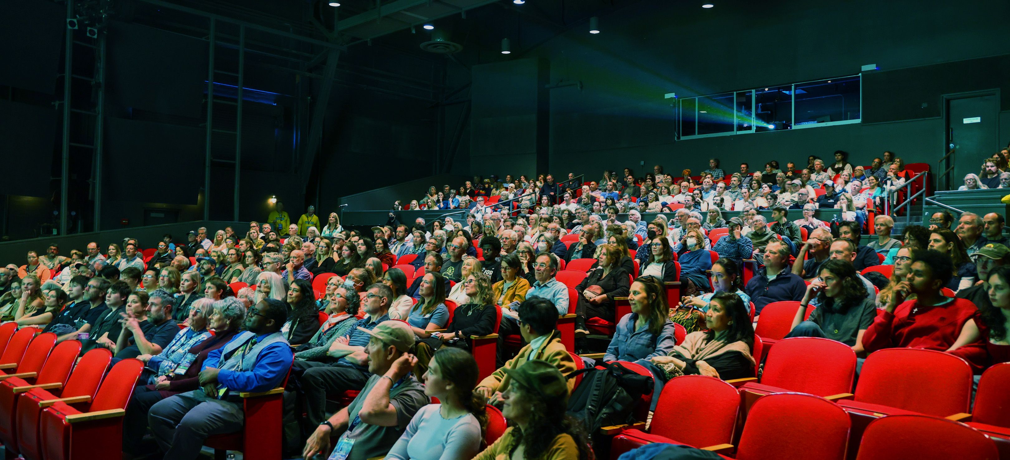 people sitting in movie theatre watching a film