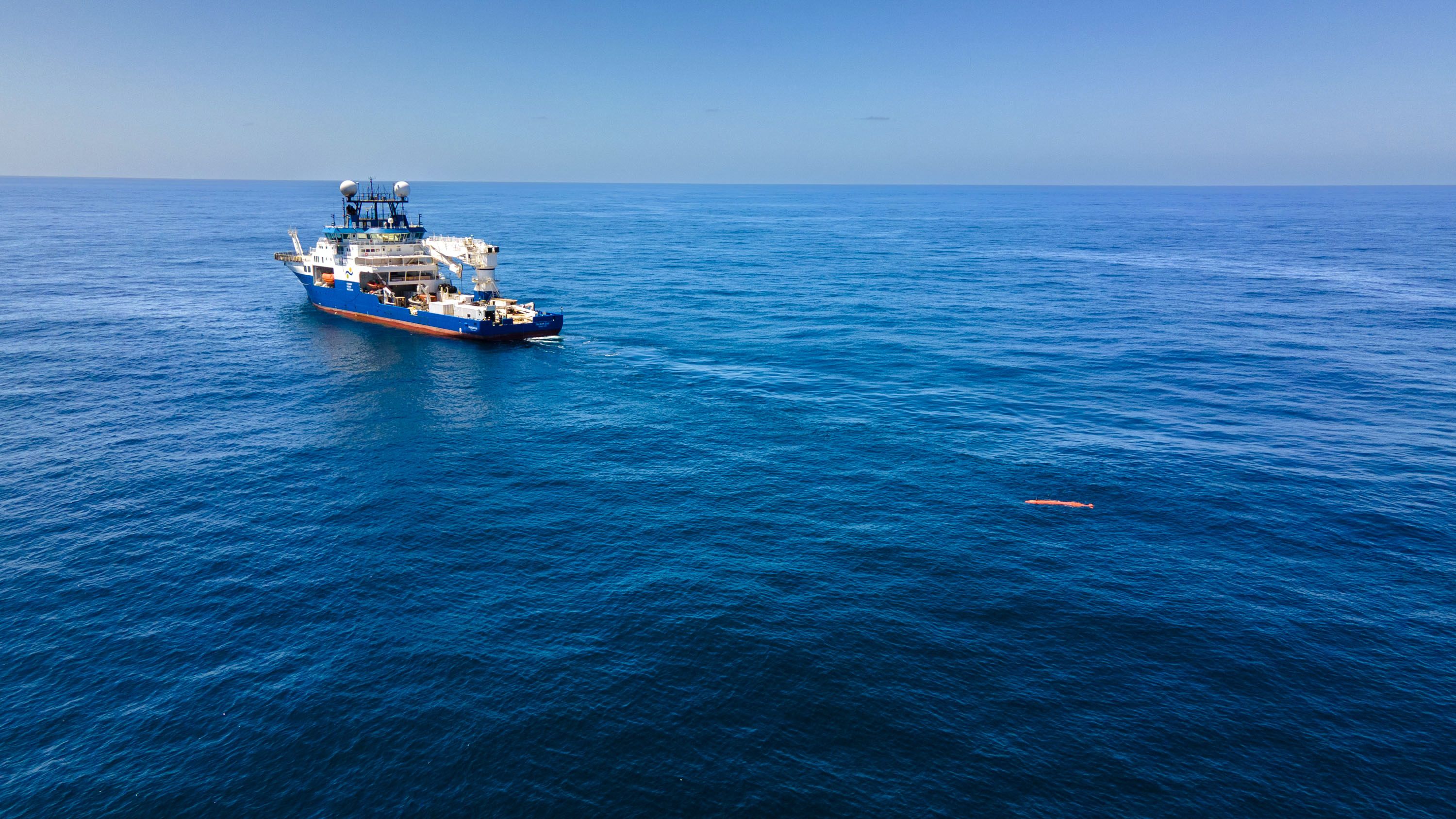 Aerial footage of the RV Falkor (too) and the AUV in the water. 
