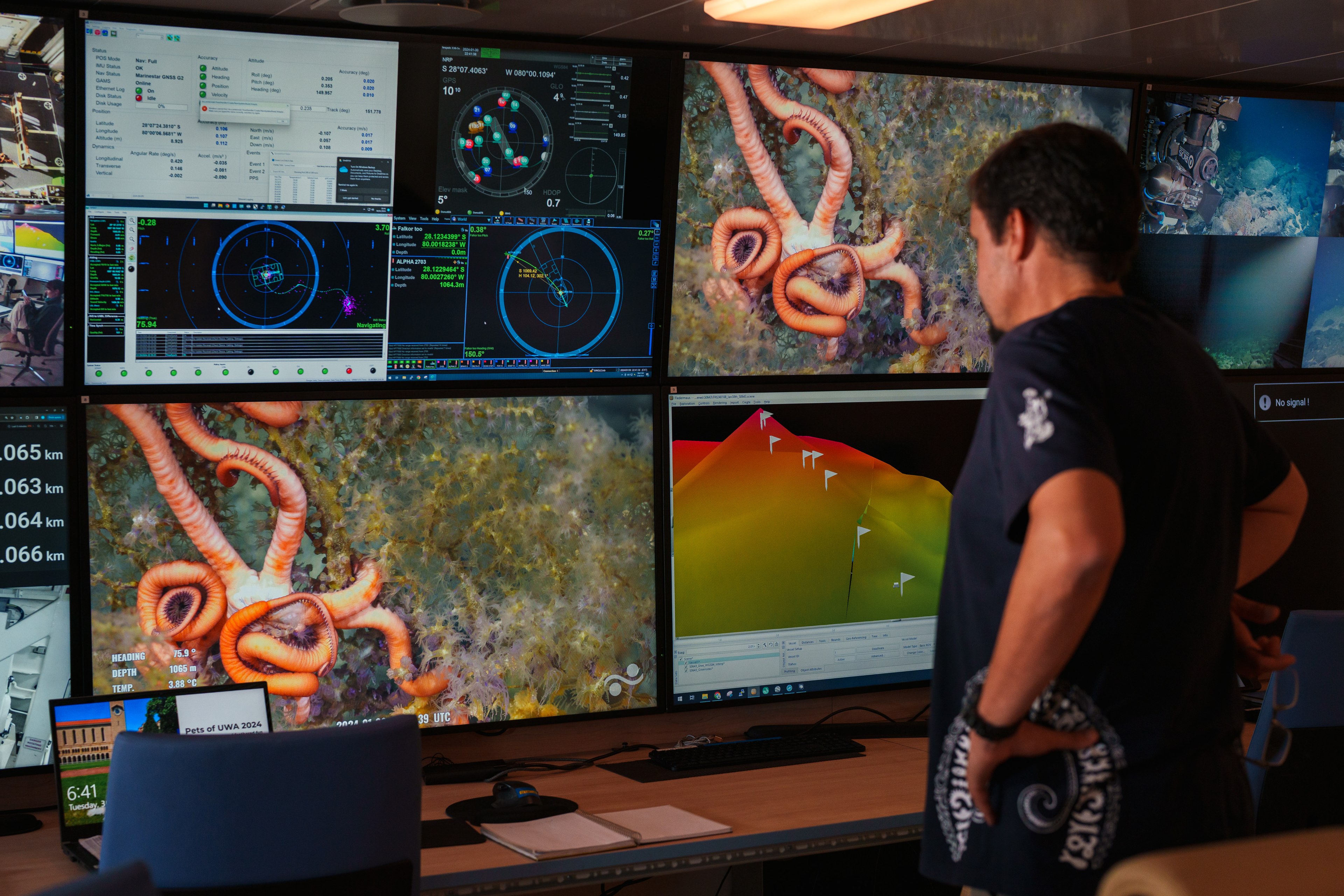 Chief Scientist looking at screens in the computer lab during a dive.