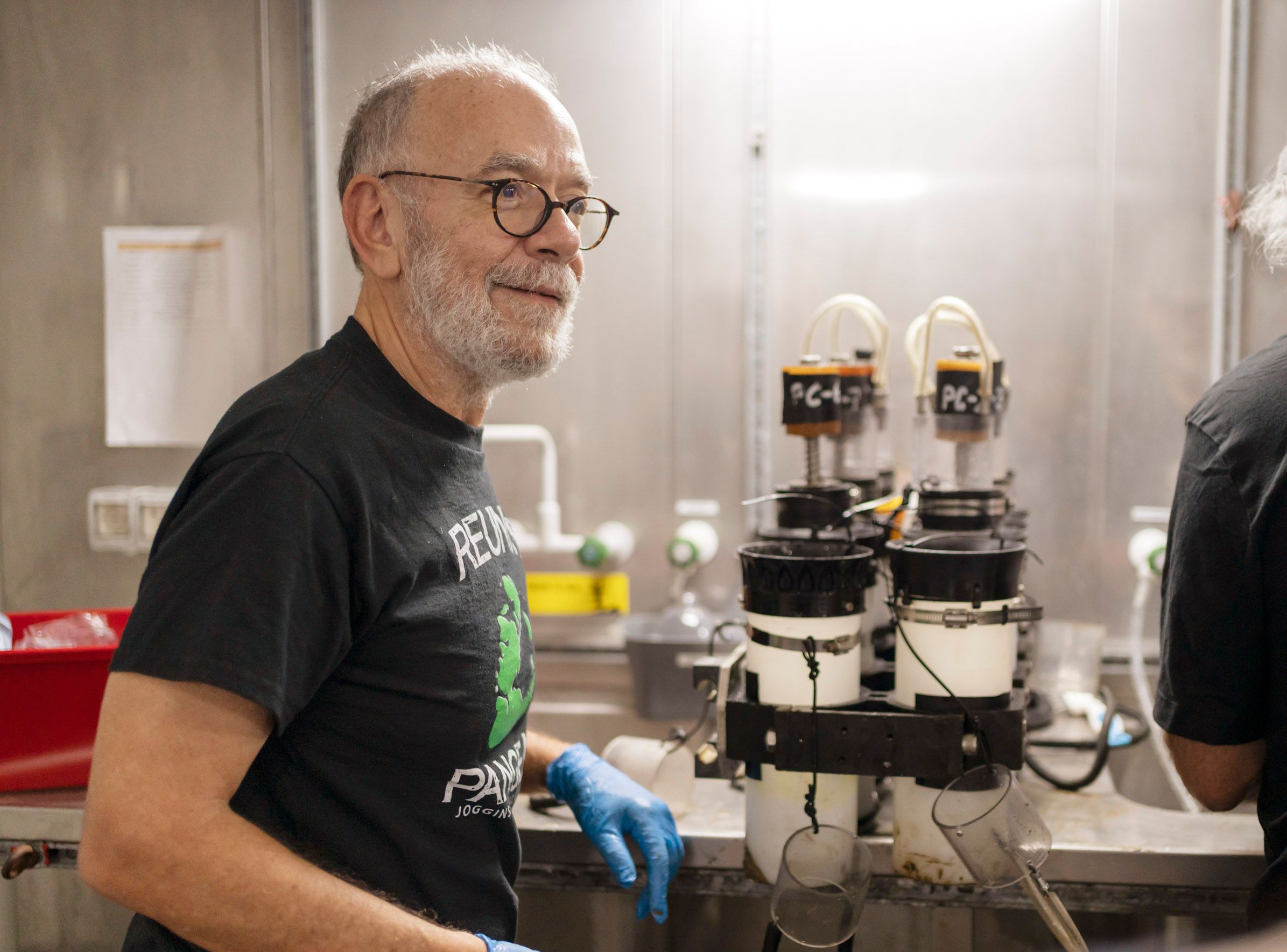 Man smiling in front of a laboratory table