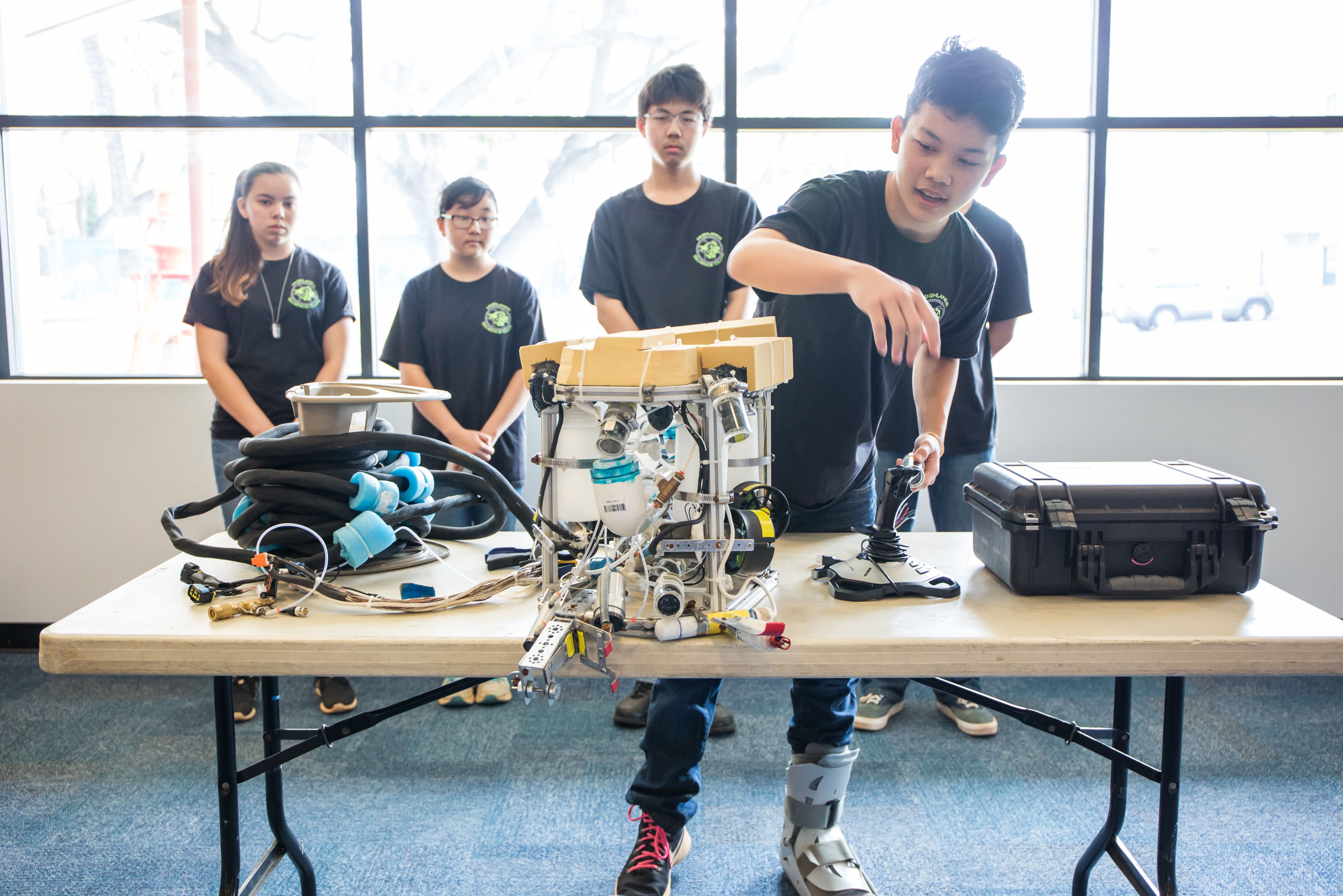 group of students explain their entry into an ROV creation competition