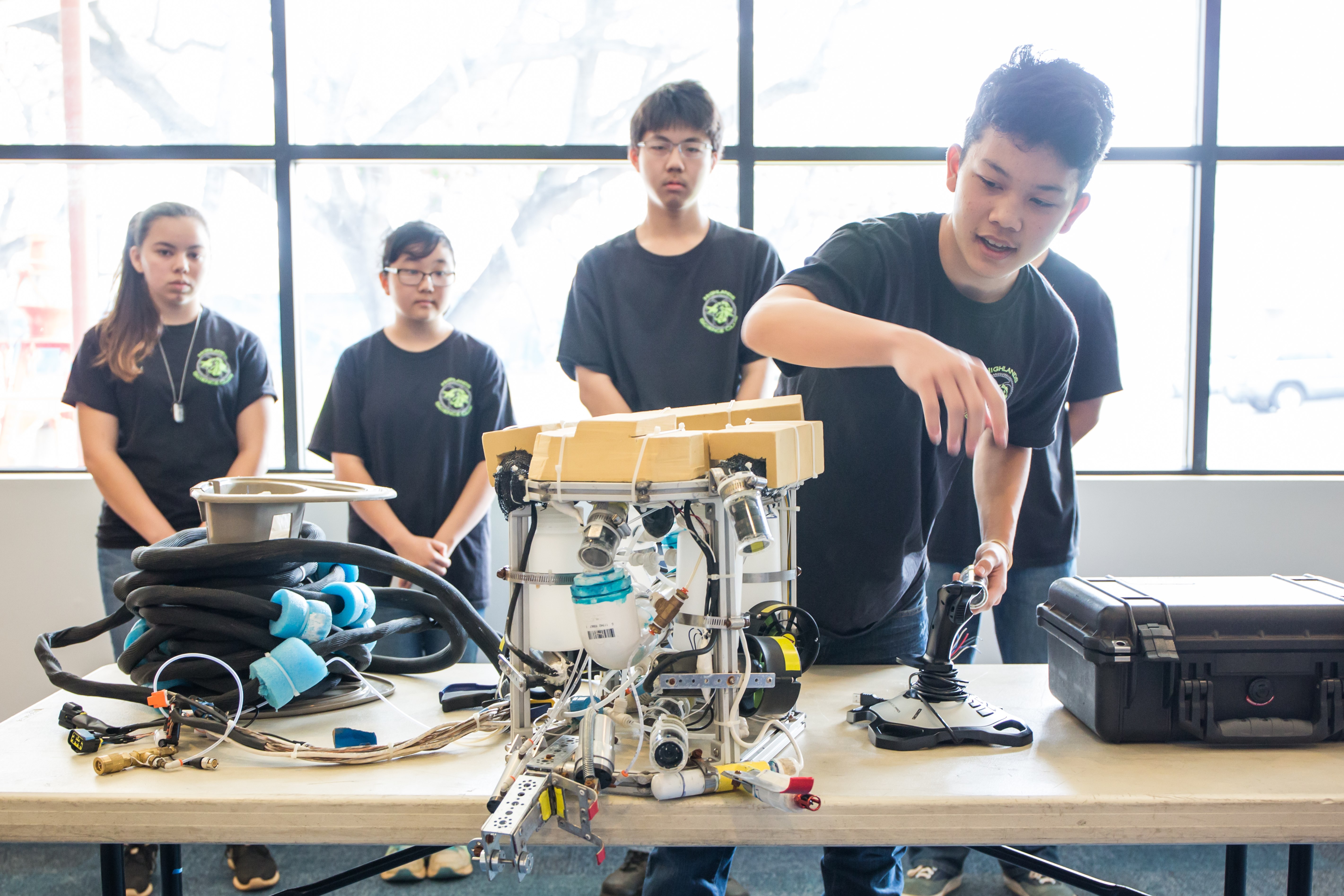 group of students explain their entry into an ROV creation competition