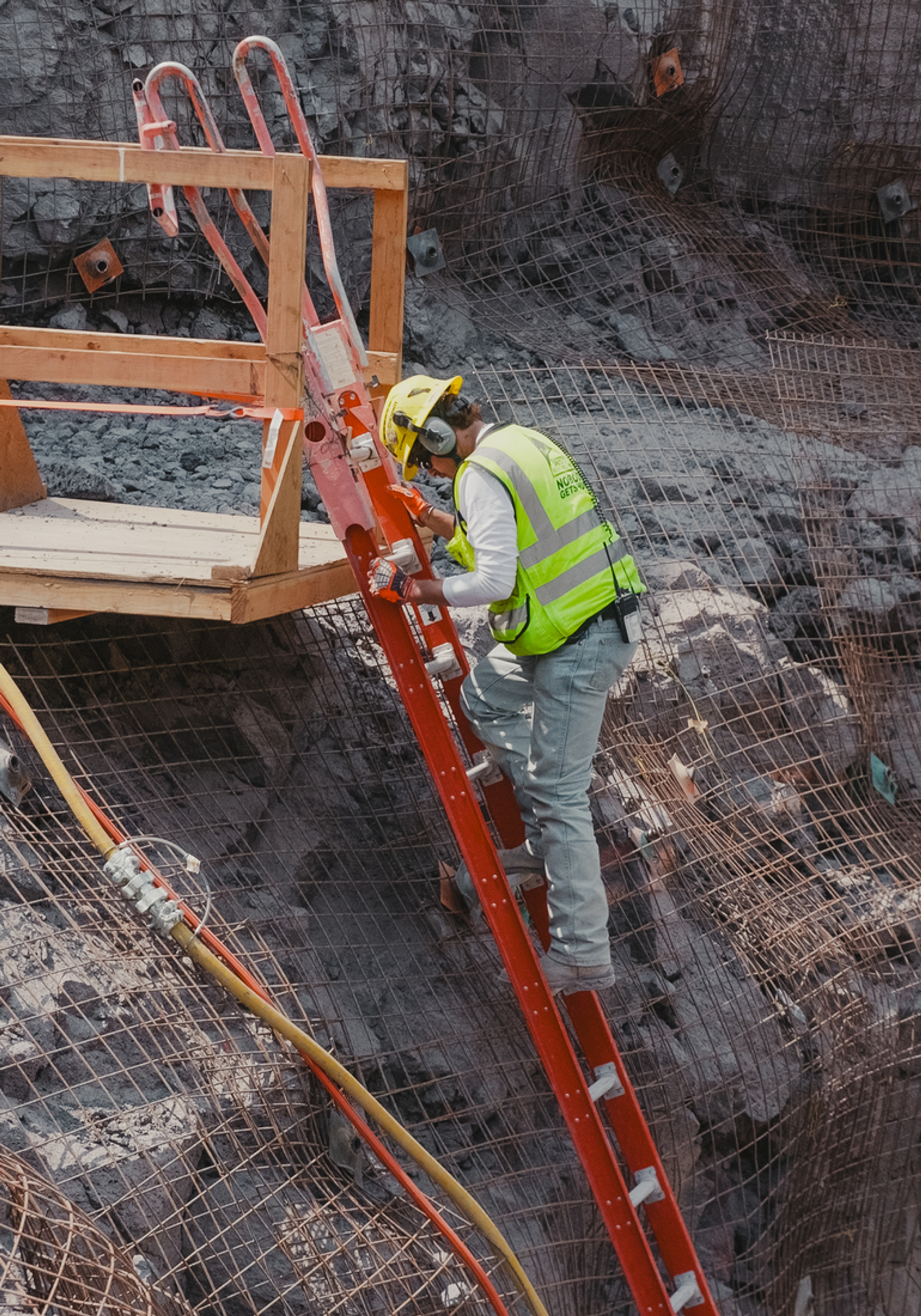 Worker climbing a ladder out of a trench at the Idaho site