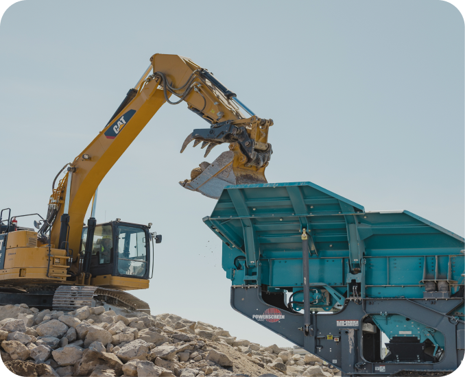 Excavator loading rock into a screening plant