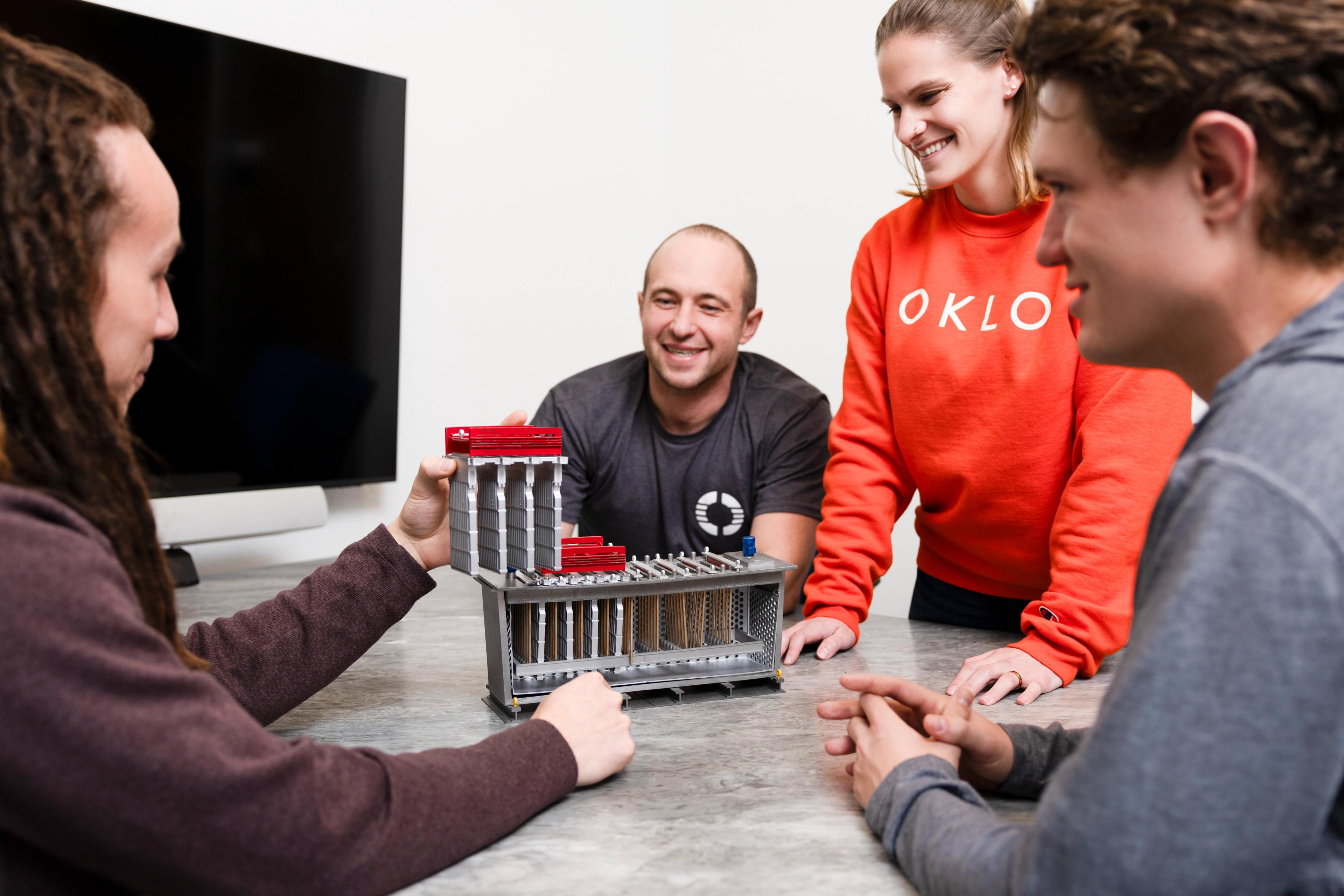 Oklo team inspecting a fuel assembly model
