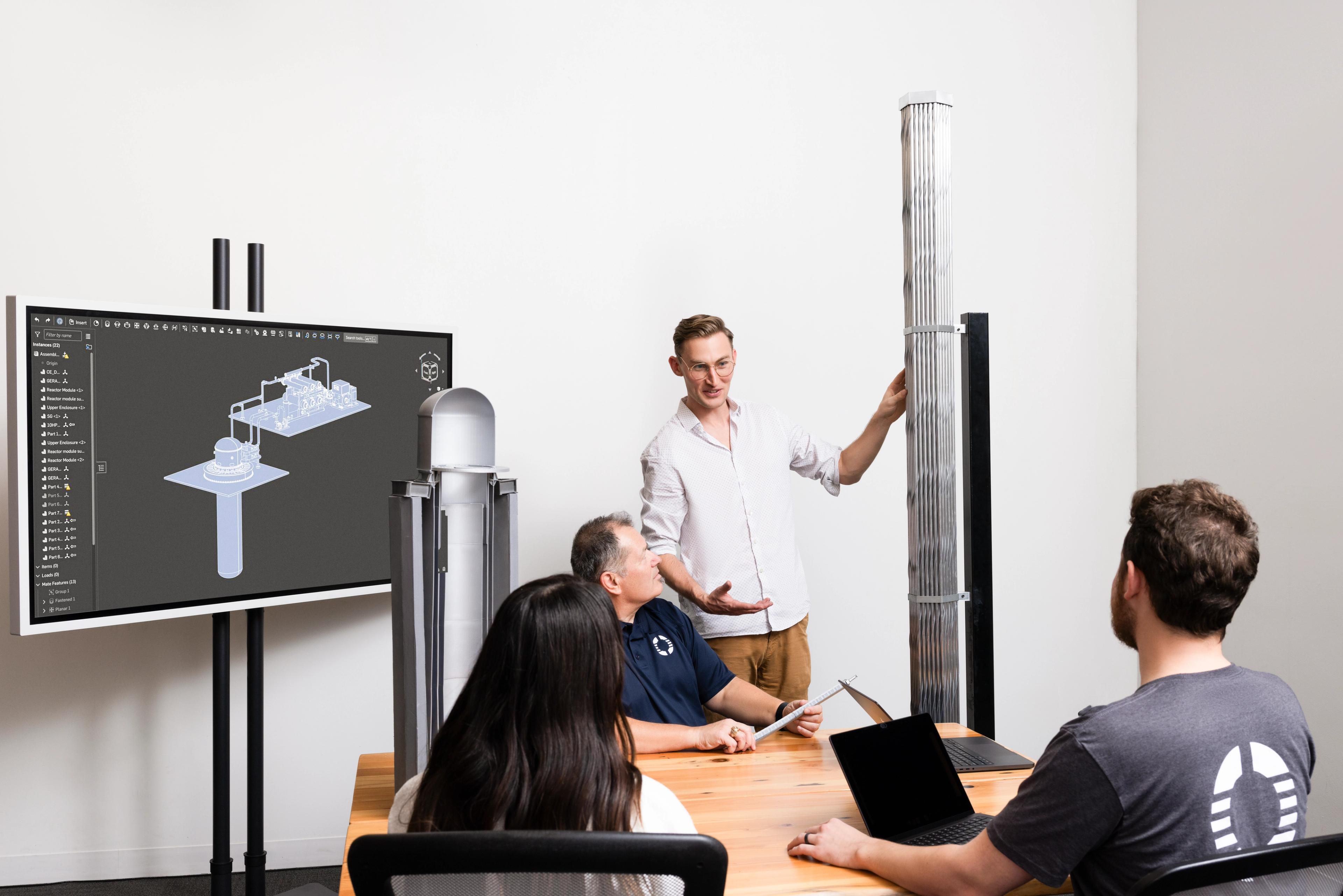 Engineers reviewing a powerhouse design on screen