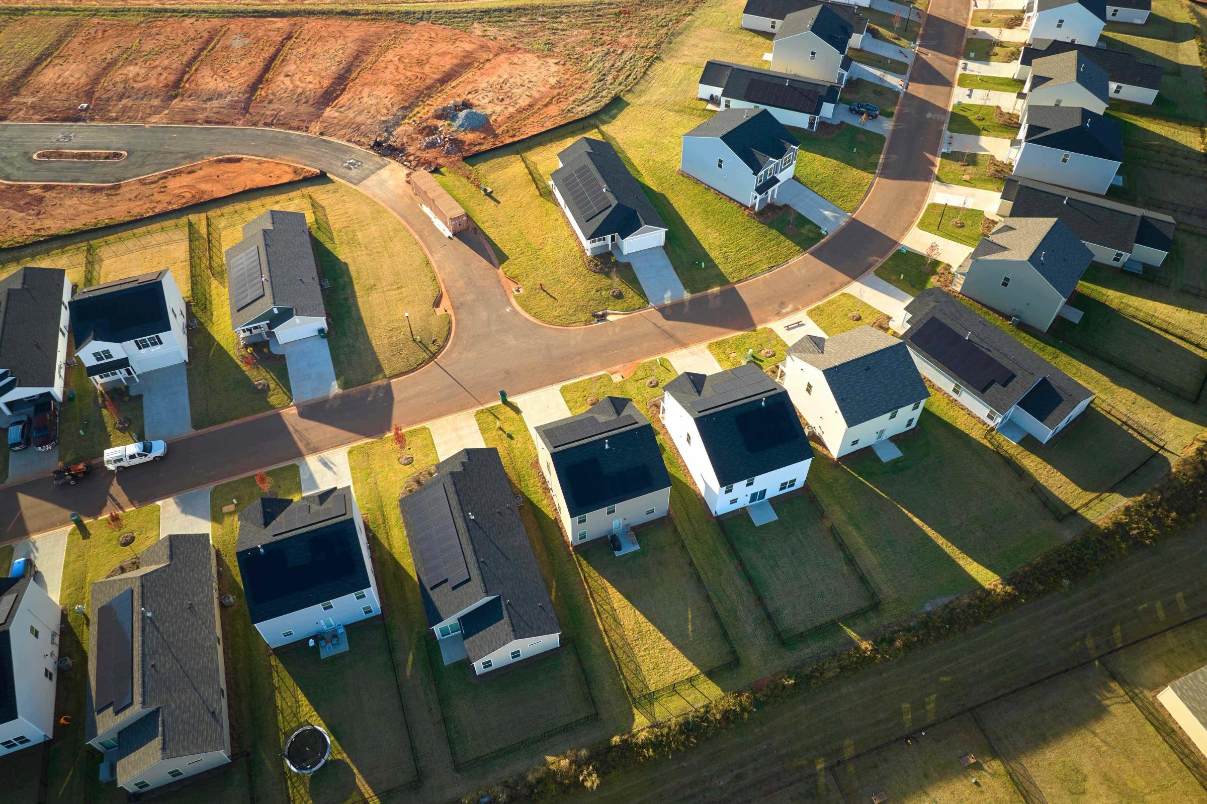 Aerial view of neighbourhood homes with rooftop solar and connected street network