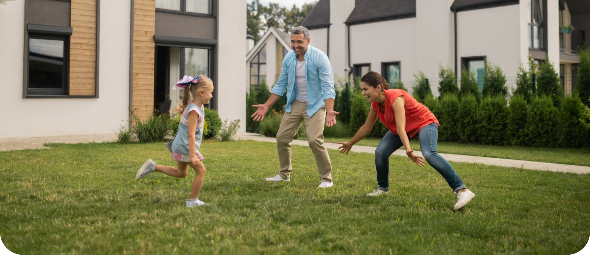 A family playing together in the garden outside their home