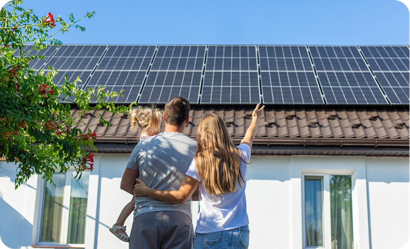 Family looking at solar panels on their home