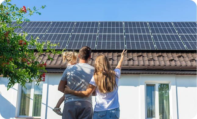 Family looking at solar panels on their home