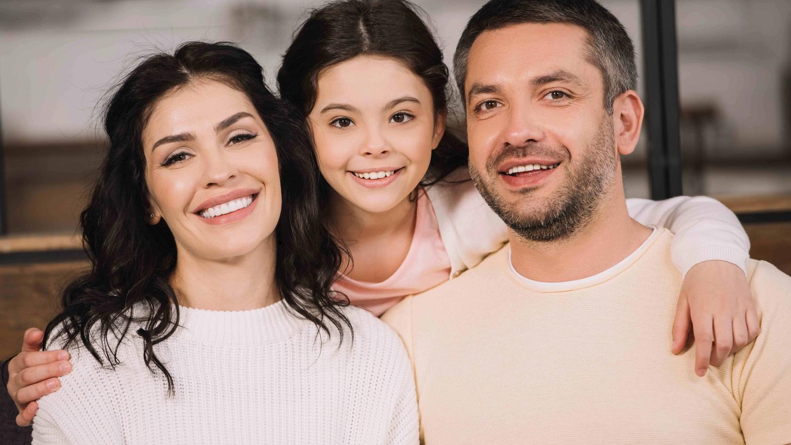 Family smiling together at home