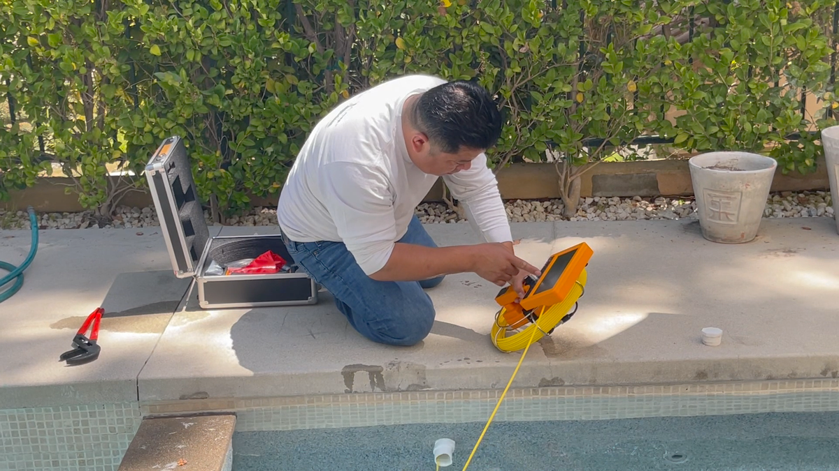 Hand Held Video Pro camera confirming the leak location inside the pipe