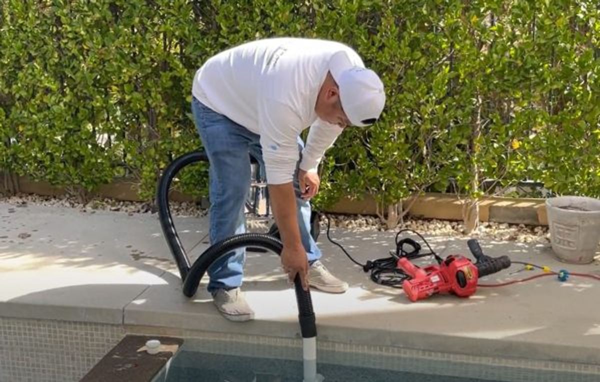 Blower clearing sanding debris out of the prepared pipe