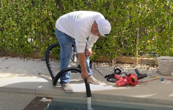 Blower clearing sanding debris out of the prepared pipe
