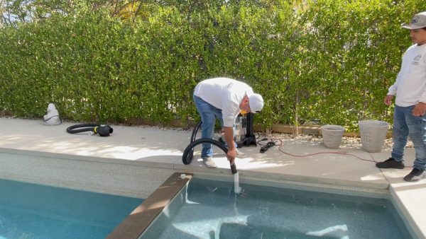 Blower/vacuum purging water out of the pool return line