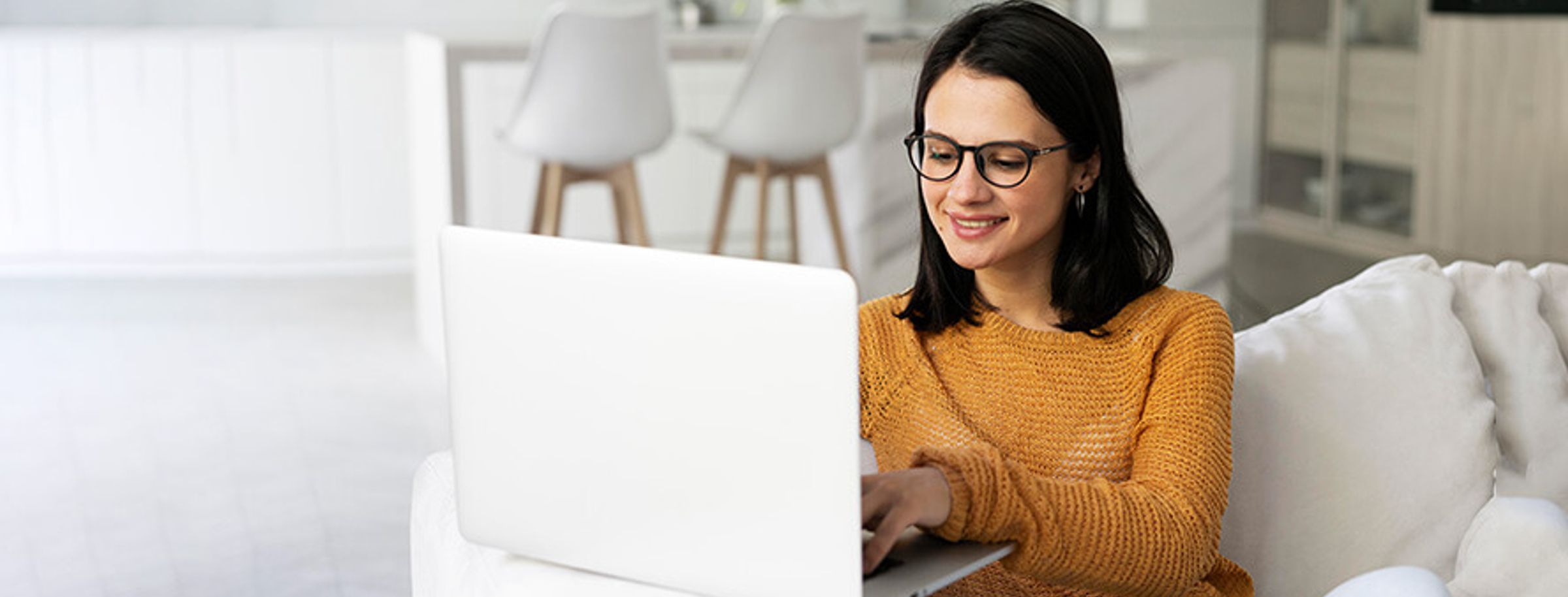 A woman shopping online on a laptop at home