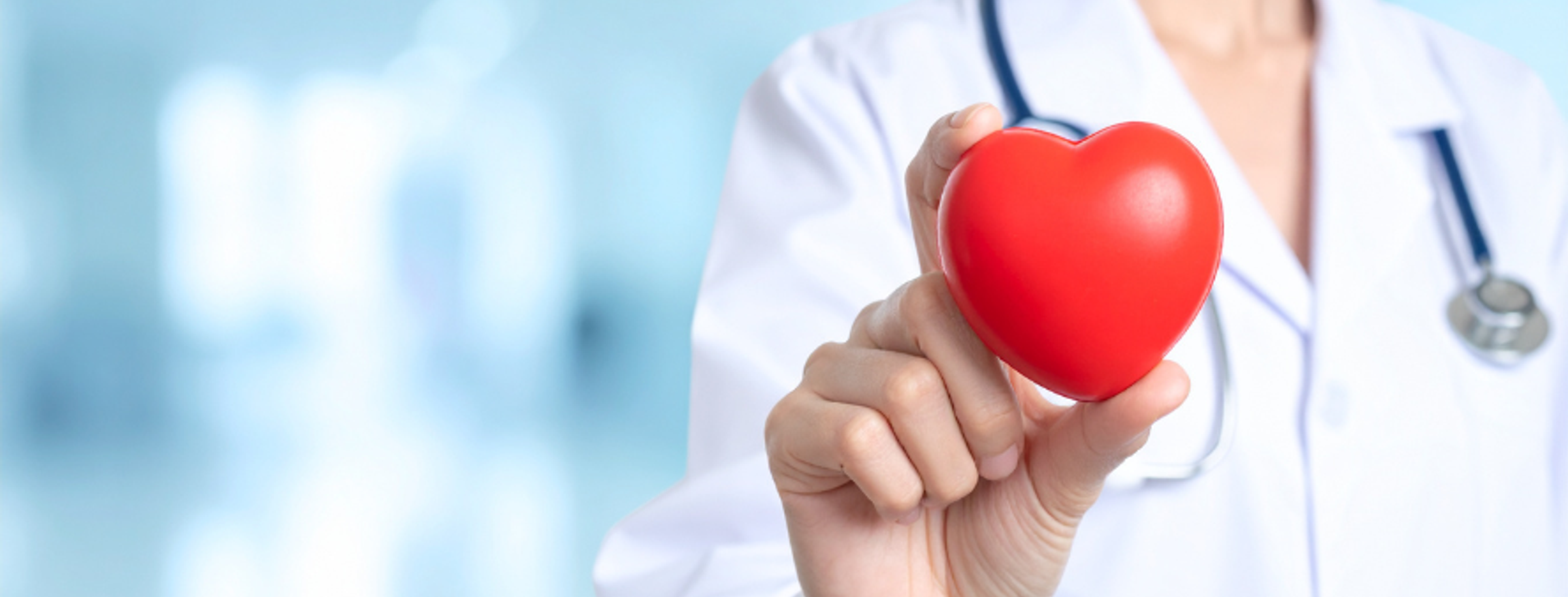 A person holding a red heart shape in their hands