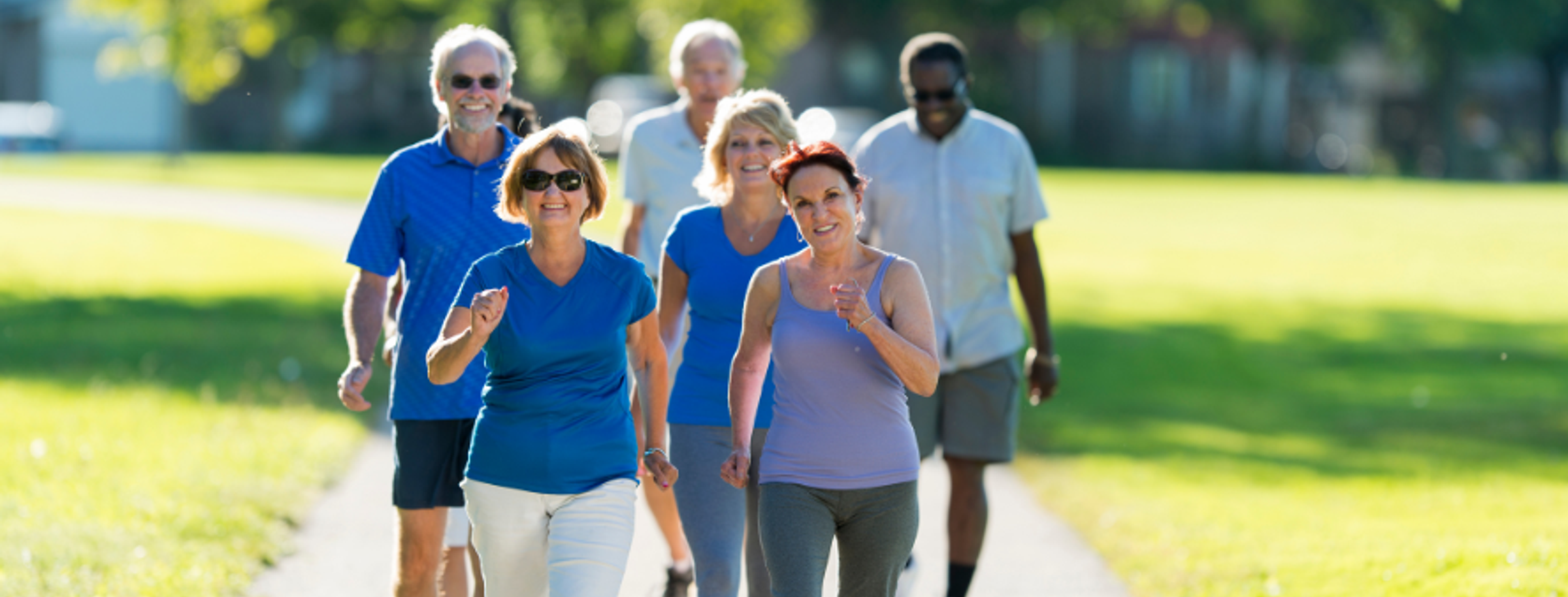 A person walking along a path in trainers