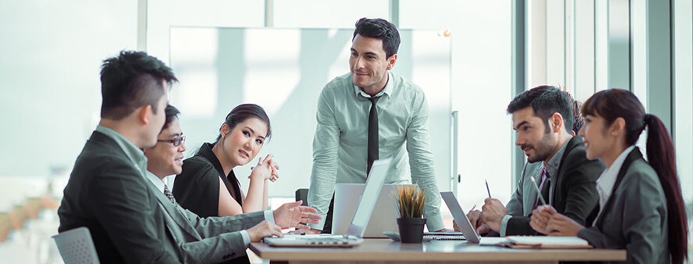 Colleagues meeting around a table in an office