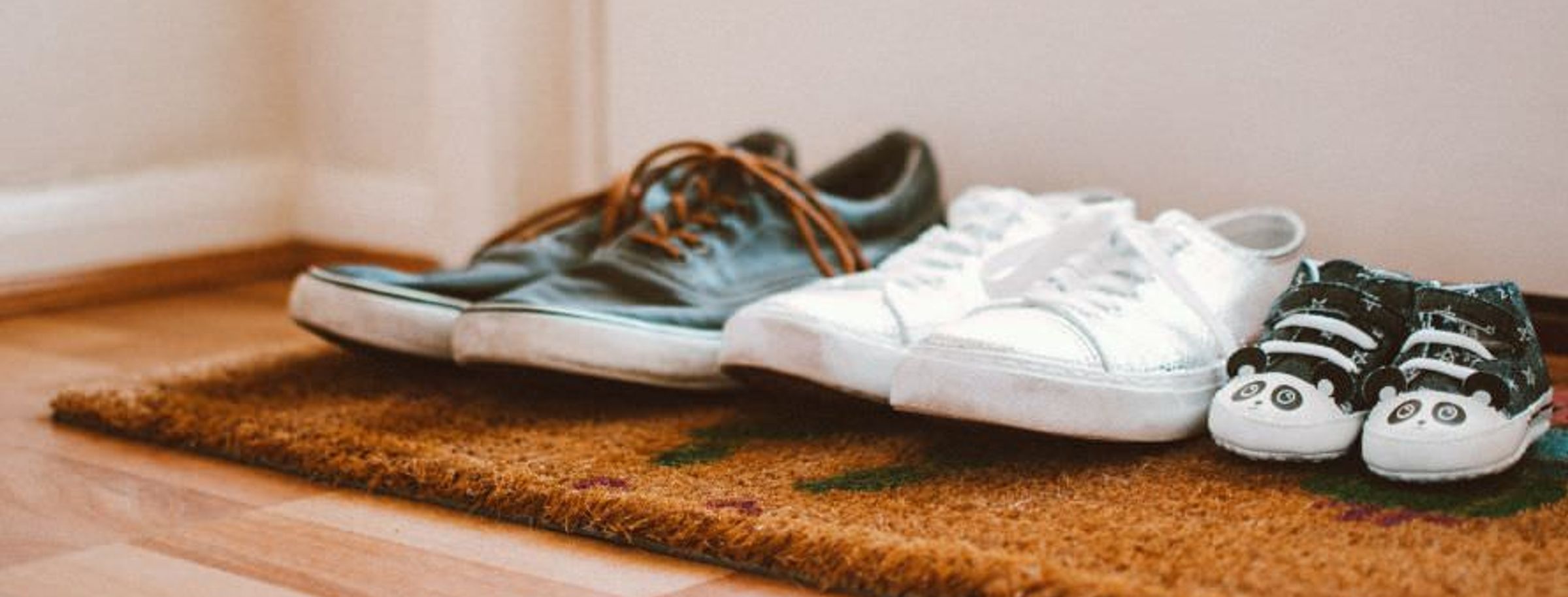 Family shoes on a doormat