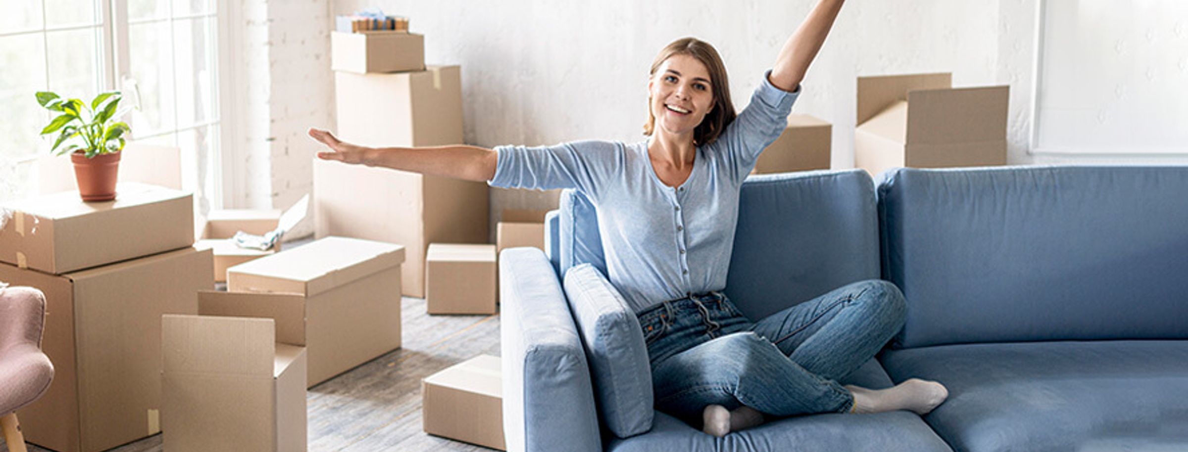 A woman sitting on a couch in her new home abroad